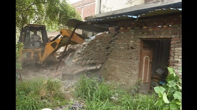 A JCB machine demolishing an illegal building on the banks of the Buddha Nullah in Ludhiana on Saturday. (Gurpreet Singh/HT) A JCB machine demolishing an illegal building on the banks of the Buddha Nullah in Ludhiana on Saturday. (Gurpreet Singh/HT)