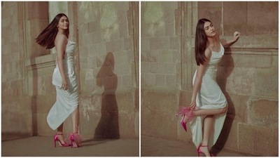 Mrunal Thakur effortlessly pulls off this chic look in an off-white satin slip dress teamed with a pair of vibrant pink stilettoes. (Instagram/@mrunalthakur)