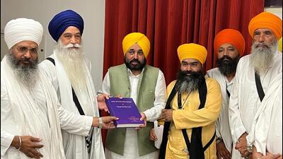 Punjab chief minister Bhagwant Mann handing over a copy of the final investigation report into the Bargari sacrilege cases in 2015 to Sikh leaders on Saturday. (HT Photo) Punjab chief minister Bhagwant Mann handing over a copy of the final investigation report into the Bargari sacrilege cases in 2015 to Sikh leaders on Saturday. (HT Photo)