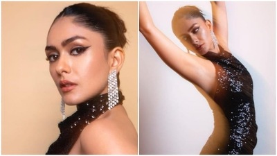 In another set of Instagram pictures, Mrunal Thakur can be seen flaunting her curves in a black shimmery figure-grasping ball room dress. (Instagram/@mrunalthakur)