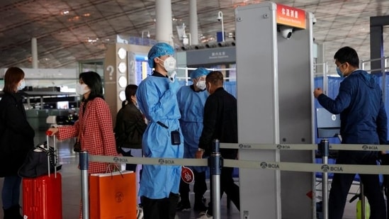 Medical staff members check the temperature of people as they enter at Capital Airport.(Reuters)