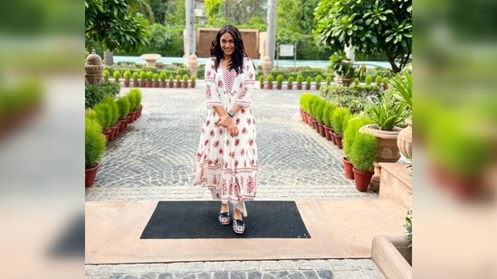 Mrunal Thakur gets snapped in candid in front of an aesthetic background featuring palm trees and greenery.(Instagram/@mrunalthakur)
