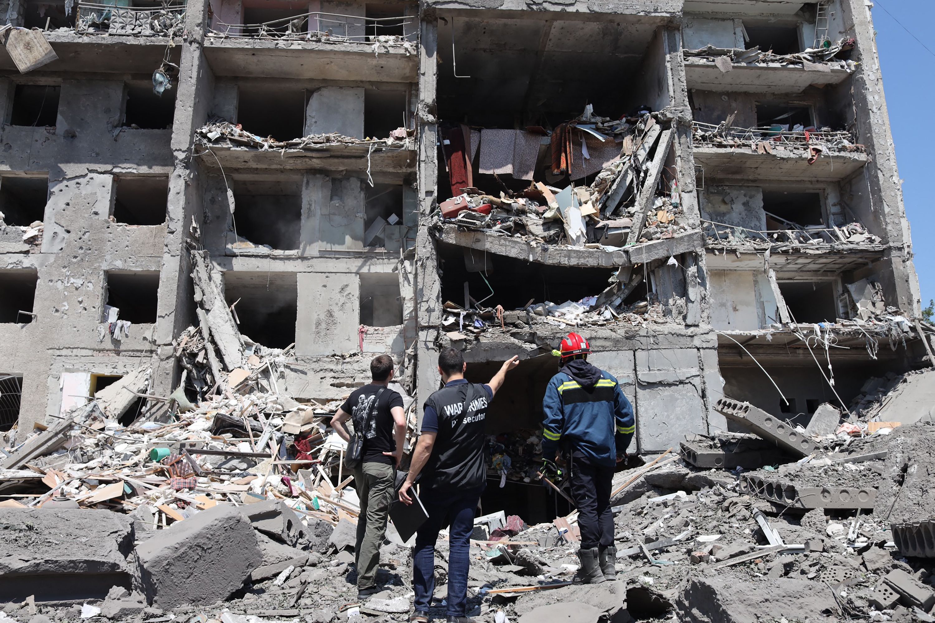 A war crimes prosecutor and a rescuer and a civil, look at a destroyed building after being hit by a missile strike in the Ukrainian town of Sergiyvka , near Odessa, on July 1, 2022. (AFP) A war crimes prosecutor and a rescuer and a civil, look at a destroyed building after being hit by a missile strike in the Ukrainian town of Sergiyvka , near Odessa, on July 1, 2022. (AFP)