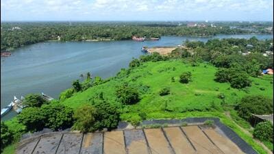A 15.8 acre of island dumped with waste, situated on the low-lying banks of ecologically-sensitive Ashtamudi Lake, is getting cleared through a reclamation project that is into final stages. (HT Photo)