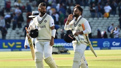 India's Cheteshwar Pujara, left, and India's Rishabh Pant leave the field at the end of play on the third day of the fifth Test (AP)