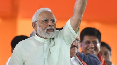 &nbsp;Prime Minister Narendra Modi waves towards his party supporters as he arrives to address a public meeting at parade grounds in Secunderabad, the twin city of Hyderabad on Sunday. (Photo by NOAH SEELAM / AFP) (AFP)