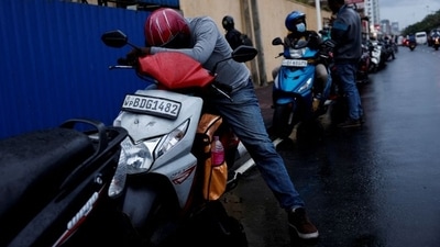 A man waits in a queue to buy petrol due to fuel shortage, amid the country's economic crisis, in Colombo, Sri Lanka. (Reuters)