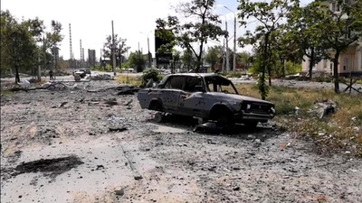 In this photo provided by the Luhansk region military administration, burned car and damaged residential buildings are seen in Lysychansk, Luhansk region, Ukraine. (AP) In this photo provided by the Luhansk region military administration, burned car and damaged residential buildings are seen in Lysychansk, Luhansk region, Ukraine. (AP)