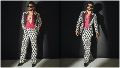 Ranveer embraced the print-on-print sartorial trend for appearing on Koffee With Karan season 7 with Alia Bhatt. The star donned a notch-lapel blazer decked with a black star-shaped pattern on a white backdrop. It also features long sleeves, an open front, patch pockets, and padded shoulders. (Instagram) Ranveer embraced the print-on-print sartorial trend for appearing on Koffee With Karan season 7 with Alia Bhatt. The star donned a notch-lapel blazer decked with a black star-shaped pattern on a white backdrop. It also features long sleeves, an open front, patch pockets, and padded shoulders. (Instagram)
