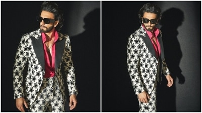 Ranveer styled his black and white printed suit with a pendant-adorned chain, leather-strapped watch, quirky black tinted sunglasses, diamond ear studs, and black suede leather dress shoes. Lastly, a back-swept hairdo and groomed beard rounded off Ranveer's look. (Instagram) Ranveer styled his black and white printed suit with a pendant-adorned chain, leather-strapped watch, quirky black tinted sunglasses, diamond ear studs, and black suede leather dress shoes. Lastly, a back-swept hairdo and groomed beard rounded off Ranveer's look. (Instagram)