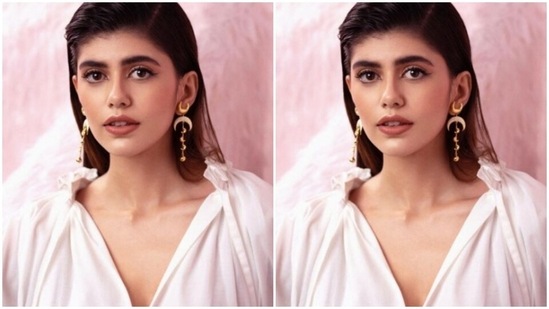 Sanjana decked up in a white top with dramatic full sleeves and a plunging neckline, she teamed it with a white high-waisted pencil skirt featuring a white lace.(Instagram/@sanjanasanghi96)