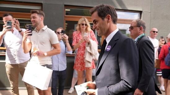 Switzerland's Roger Federer walks outside Centre Court on day seven of the Wimbledon tennis championships.(AP)