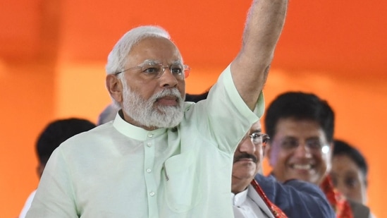 &nbsp;Prime Minister Narendra Modi waves towards his party supporters as he arrives to address a public meeting at parade grounds in Secunderabad, the twin city of Hyderabad on Sunday. (Photo by NOAH SEELAM / AFP)(AFP)