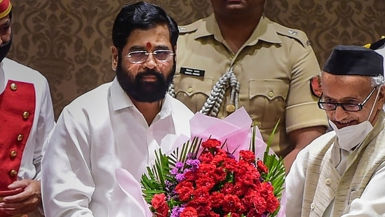 Mumbai: Newly elected Maharashtra Chief Minister Eknath Shinde being presented a bouquet by Governor Bhagat Singh Koshyari during his oath-taking ceremony, at Raj Bhavan in Mumbai,&nbsp;(PTI)