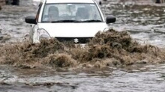 A car wades through the waterlogged road following heavy rainfall, in New Delhi, on July 3, 2022.&nbsp;(ANI Photo)