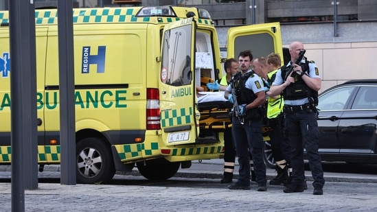 An ambulance and armed police are seen during the evacuation of people at the Fields shopping center in Copenhagen, Denmark, on July 3, 2022 after Danish media reported a shooting. (Photo by Olafur Steinar Gestsson/Ritzau Scanpix/AFP)