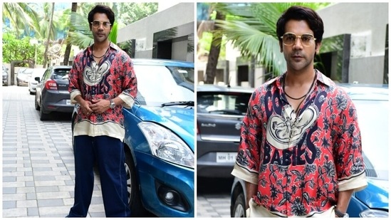 Rajkummar teamed the shirt with dark blue oversized denim pants, matching sneakers, a leather strap watch, a layered chain, retro gold-framed sunglasses, a side-parted hairdo and a clean shave look. He channelled boho-chic vibes with his trendy outfit.(HT Photo/Varinder Chawla)