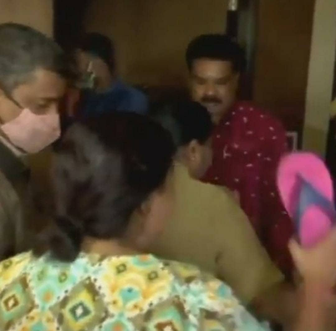 Ramya Raghupathi with a slipper in her hand trying to hit Naresh and Pavithra Lokesh.