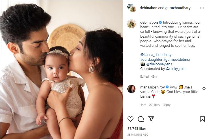 The couple shared a picture of themselves holding and kissing their daughter.