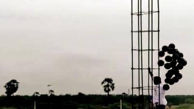 A Congress worker releases black balloons moments after Prime Minister Narendra Modi's chopper took off, during his visit to Andhra Pradesh on Tuesday. (ANI) A Congress worker releases black balloons moments after Prime Minister Narendra Modi's chopper took off, during his visit to Andhra Pradesh on Tuesday. (ANI)