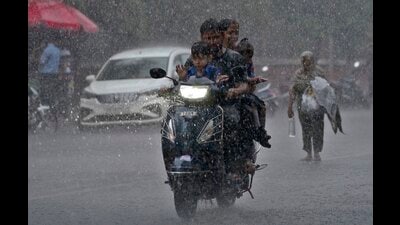 A family on a scooter makes its way through the incessant rain in Ludhiana. (Gurpreet Singh/HT) A family on a scooter makes its way through the incessant rain in Ludhiana. (Gurpreet Singh/HT)