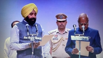 Punjab minister Fauja Singh Sarari administered oath by governor Banwari Lal Purohit. (Twitter/AAP Punjab) Punjab minister Fauja Singh Sarari administered oath by governor Banwari Lal Purohit. (Twitter/AAP Punjab)