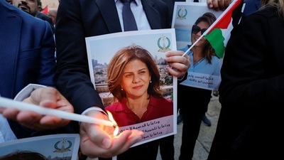 People light candles during a vigil in memory of Al Jazeera journalist Shireen Abu Akleh, who was killed during an Israeli raid, outside the Church of the Nativity in Bethlehem, in the Israeli-occupied West Bank. (REUTERS)