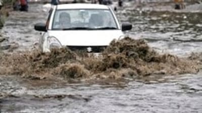 A car wades through the waterlogged road following heavy rainfall, in New Delhi, (ANI Photo) A car wades through the waterlogged road following heavy rainfall, in New Delhi, (ANI Photo)