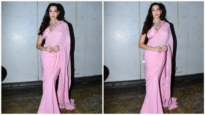 Nora draped the semi-sheer six yards in traditional style, letting the pallu drop elegantly from her shoulders. It also featured heavy embellishments and feather adornments that helped elevate the elegance quotient of the attire. (HT Photo/Varinder Chawla) Nora draped the semi-sheer six yards in traditional style, letting the pallu drop elegantly from her shoulders. It also featured heavy embellishments and feather adornments that helped elevate the elegance quotient of the attire. (HT Photo/Varinder Chawla)