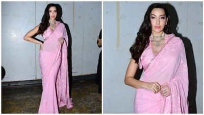 For the accessories, Nora picked ornate gold earrings, a pearl and gemstone adorned choker necklace and statement rings. A pair of matching high heels rounded it all off. (HT Photo/Varinder Chawla) For the accessories, Nora picked ornate gold earrings, a pearl and gemstone adorned choker necklace and statement rings. A pair of matching high heels rounded it all off. (HT Photo/Varinder Chawla)