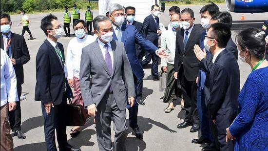 Chinese foreign minister Wang Yi (centre) is welcomed by Myanmar foreign ministry representatives and Chinese embassy officials upon his arrival at Nyaung Oo Airport in Bagan, Myanmar on Saturday. (AP)