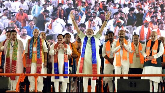 Prime Minister Narendra Modi waves to his supporters during the Vijaya Sankalpa Sabha in Hyderabad on Sunday. (ANI Photo)