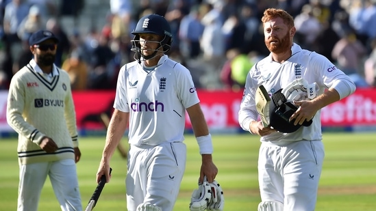 England's Jonny Bairstow, right, walks off the field with batting partner Joe Root(AP)