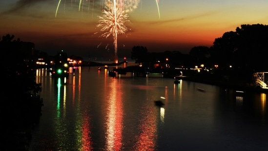 Fourth of July fireworks are reflected in the St. Joseph River on July 3 during a fireworks display in St. Joseph, Mich. (AP)