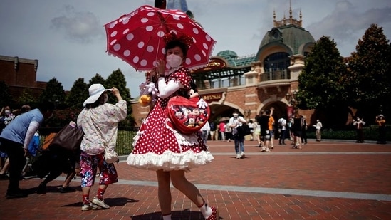 A visitor wearing a face mask poses at the Shanghai Disney Resort, as the Shanghai Disneyland theme park reopens after being shut for the coronavirus disease.&nbsp;(REUTERS)