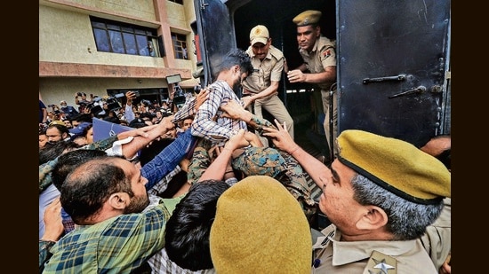 An accused in the Kanhaiya Lal killing case being taken away by the public after he was produced at an NIA court, Jaipur, July 2, 2022. (PTI)