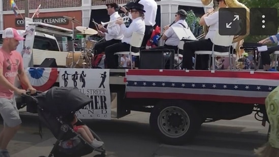 A Fourth of July parade-goer runs for cover after gunfire was heard at the parade Monday morning, in a suburb of Chicago.