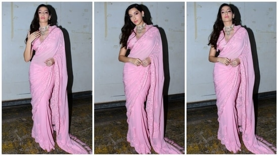 Nora's blush pink saree features several intricate design details, making it a perfect pick for attending day festivities or your best friend's wedding functions. It comes with gold sequin embellishments on the borders and floral thread embroidery decked with shimmering diamantes.(HT Photo/Varinder Chawla)