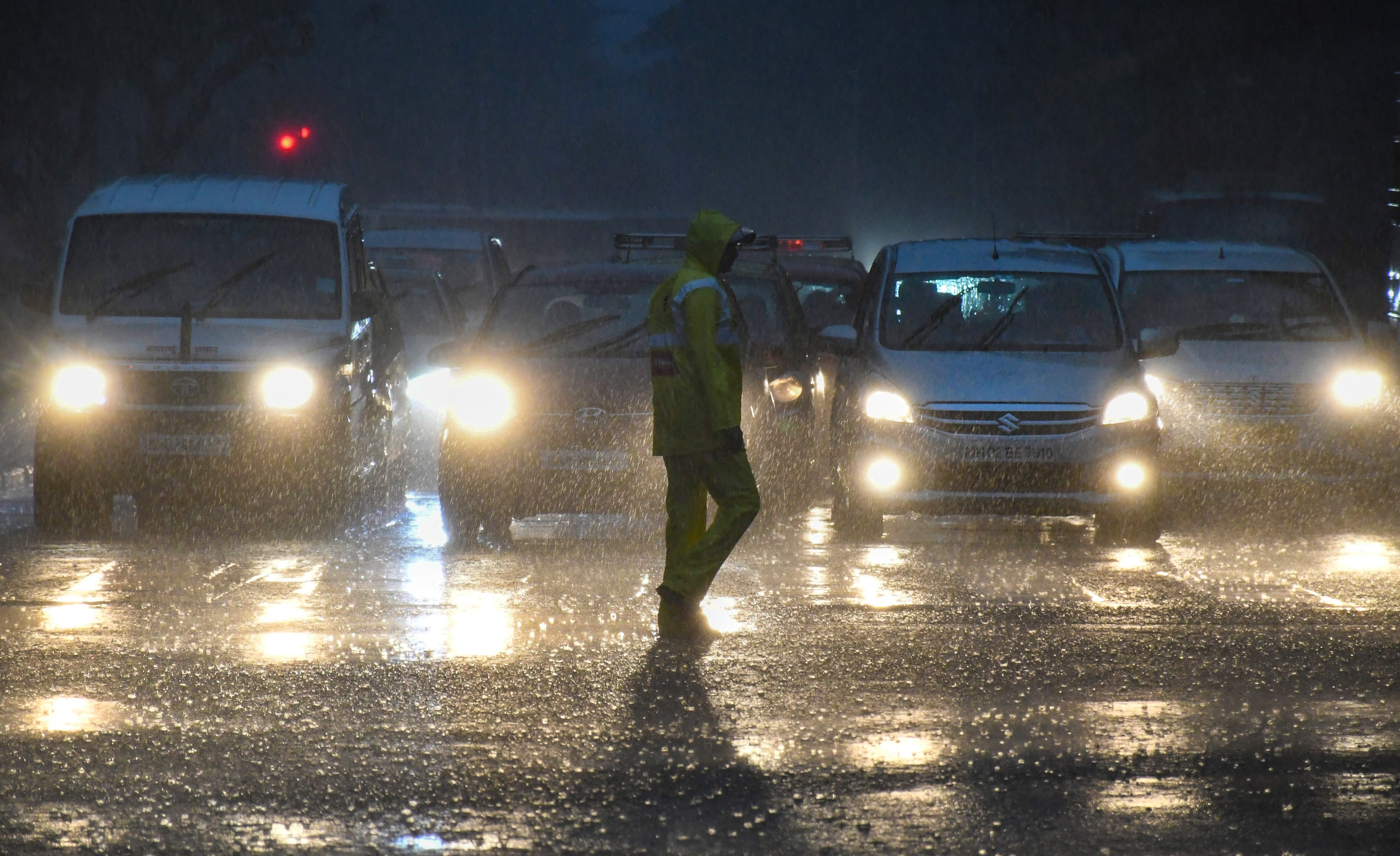 Vehicles ply on a road amid monsoon rains, in Mumbai on Monday. (PTI) Vehicles ply on a road amid monsoon rains, in Mumbai on Monday. (PTI)