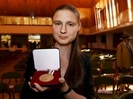 Ukraine's Maryna Viazovska presents her medal after receiving the 2022 Fields Prize for Mathematics during the International Congress of Mathematicians 2022 (ICM 2022) in Helsinki, Finland.(AFP)