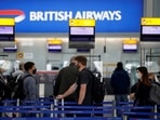 Passengers stand in a queue to the British Airways check-in desks in the departures area of Terminal 5 at Heathrow Airport in London, Britain&nbsp;
