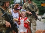 Law enforcement escorts a family away from the scene of a shooting at a Fourth of July parade on July 4, 2022 in Highland Park, Illinois, Chicago, in the United States. Mark Borenstein/Getty Images/AFP