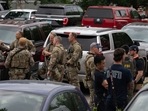 Officers gather at the scene of the Fourth of July parade shooting in Highland Park, Illinois.&nbsp;