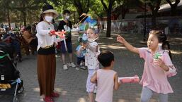 Children play with bubbles at a park during Dragon Boat festival holiday in Beijing, China on June 4, 2022. (REUTERS)