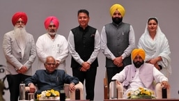 Punjab governor Banwarilal Purohit and chief minister Bhagwant Mann along with (standing, L-R) new cabinet ministers Inderbir Singh Nijjar, Chetan Singh Jouramajra, Aman Arora, Fauja Singh Sarari and Anmol Gagan Mann after the oath ceremony at the Raj Bhawan in Chandigarh on Monday.&nbsp;