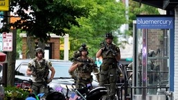 Law enforcement search after a mass shooting at the Highland Park Fourth of July parade in downtown Highland Park, Ill., Monday, July 4, 2022. A gunman on a rooftop opened fire on an Independence Day parade in suburban Chicago on Monday. (AP Photo/Nam Y. Huh)
