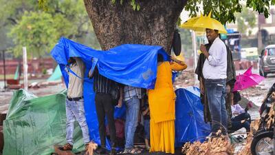 People take shelter under a tree during heavy rainfall in New Delhi earlier this week. (PTI Photo) People take shelter under a tree during heavy rainfall in New Delhi earlier this week. (PTI Photo)