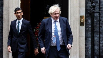 British Prime Minister Boris Johnson and Chancellor of the Exchequer Rishi Sunak walk out of Downing Street. (REUTERS)