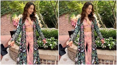 Rakul Preet teamed a pink floral cropped top with a plunging neckline with a pair of pink sharara set that came intricately detailed in miniature floral patterns. She added more drama to her look with a black long shrug with multicoloured patterns. (Instagram/@rakulpreet)