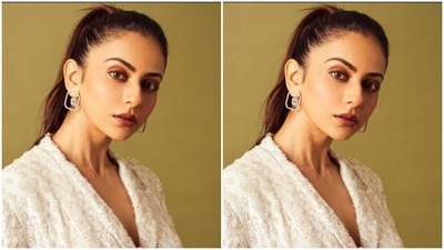 Rakul Preet teamed a white blazer that came with a belt detail at the waist and decorations in silver threads with a pair of white formal trousers. (Instagram/@rakulpreet)
